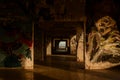 Wide square-shaped hallway of an abandoned damaged building with walls covered in graffiti