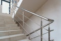 A wide staircase along the large windows in an office building. Modern interior of the lobby of an office building with large Royalty Free Stock Photo