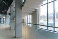 A wide staircase along the large windows in an office building. Modern interior of the lobby of an office building with large Royalty Free Stock Photo