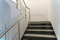 A wide staircase along the large windows in an office building. Modern interior of the lobby of an office building with large Royalty Free Stock Photo