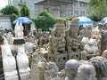 Wide statue photo of men sitting on Chinese guardian lions - Panjiayuan Market