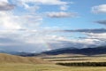 Wide steppe with yellow grass under a blue sky with white clouds Sayan mountains Siberia Russia Royalty Free Stock Photo