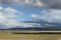 Wide steppe with yellow grass under a blue sky with white clouds Sayan mountains Siberia Russia Royalty Free Stock Photo