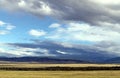 Wide steppe with yellow grass under a blue sky with white clouds Sayan mountains Siberia Russia Royalty Free Stock Photo