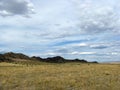 Wide steppe with yellow grass under a blue sky with white clouds Sayan mountains Siberia Russia Royalty Free Stock Photo