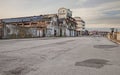 wide street in the suburbs of the city with abandoned warehouse and factory