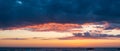 Wide sunset sky with vivid colors over ocean Royalty Free Stock Photo