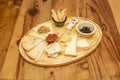 Wide table of assorted cheeses, jams, dried tomatoes, walnuts and picos