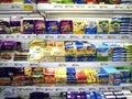 A wide variety of cheese products on display at a grocery store ready to picked up by customers