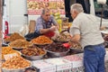 Wide variety of spices, nuts and dried fruits on the shelves of local street market traders