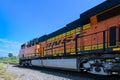 Wide view in closeup of BNSF locomotive against blue sky