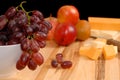 Wide view of fruit and cheese on cutting board Royalty Free Stock Photo