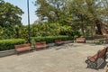 Wide view of group of unoccupied wooden seats or chairs arranged in a garden or park, Chennai, India, April 1st 2017