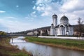 Wide view of The Holy Trinity Church in Sighisoara, and the river Tarnava Mare. Royalty Free Stock Photo