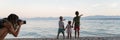 Wide view image of beautiful family moment on the beach at dusk