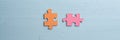 Wide view image of two blank orange and pink matching puzzle pieces Royalty Free Stock Photo