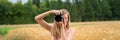 Wide view image of a young female photographer taking a photo Royalty Free Stock Photo