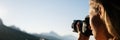 Female photographer taking photos of mountains Royalty Free Stock Photo