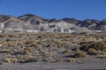 Wide view of industrial mining operation in front of large tailing piles in the desert Royalty Free Stock Photo