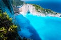 Wide view of Navagio beach with green vegetation in foreground. Famous landscape of Zakinthos island, Greece Royalty Free Stock Photo