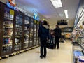 Lynnwood, WA USA - circa July 2023: Wide view of people shopping for liquor inside a QFC grocery store