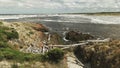 Wide view of the rugged coastline and dark tannin stained water at the arthur river mouth in tasmania