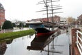 Wide view on a sailor ship and its reflection and the landscape around at the canal in papenburg germany