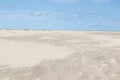 Wide view on the white sand of the beach under a blue sky on the northern sea island borkum germany Royalty Free Stock Photo