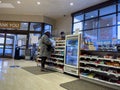 Lynnwood, WA USA - circa November 2022: Wide view of a woman checking out at the counter of a Rite Aid Pharmacy