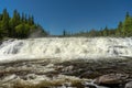 Wide waterfall in northern Sweden in bright summer sunshine