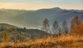 Mountain country road in multi colored autumn colors mountains in the haze Royalty Free Stock Photo