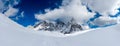 Wide winter panorama of snowy mountains