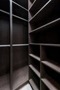 Wide wooden dressing room, interior of a modern house. Empty brown wooden shelves in the dressing room Royalty Free Stock Photo