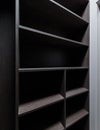 Wide wooden dressing room, interior of a modern house. Empty brown wooden shelves in the dressing room Royalty Free Stock Photo