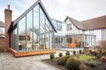 wideangle view of tudor house with modern glass extension
