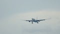 Widebody aircraft approaching over ocean