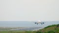 Widebody aircraft approaching over ocean