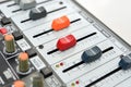 Widened faders on different sides on a mixing console, close-up