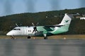 Wideroe passenger airplane on terminal