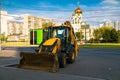 Widespread model of universal backhoe loader of JCB Company Great Britain of recognizable yellow colour.