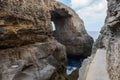 Wied il Mielah canyon, natural arch over the sea. Gozo, Malta