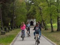 Girls on bicycle in front of chapel being part of the Way of the Cross, Kaszuby, Early spring