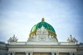 Wien, Austria - The Hofburg Palace in Vienna, ancient baroque imperial palace. Wiev of the dome and the statues on the roof Royalty Free Stock Photo