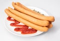 Wiener sausages, frankfurters, on a white plate, with ketchup, isolated on white background. Polish meat product.
