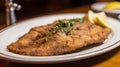 Wiener schnitzel with lemon and parsley on a plate