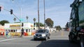 Wienerschnitzel hot dog fast food. Green garbage truck on road intersection. California 101 USA. Royalty Free Stock Photo