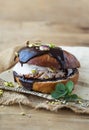 Wierd burger with vanilla ice cream and chocolated confetti on wooden background. Royalty Free Stock Photo