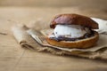 Wierd burger with vanilla ice cream and chocolated confetti on wooden background. Royalty Free Stock Photo