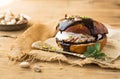 Wierd burger with vanilla ice cream and chocolated confetti on wooden background. Royalty Free Stock Photo