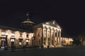 Wiesbaden casino with famous entrance with roman pillars by night